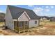 Exterior view of home featuring a covered porch with gray siding and a black roof at 9353 Turkey Way, Middlesex, NC 27557