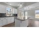 Charming kitchen with granite countertops, white cabinetry, stainless appliances, gray backsplash and pendant lighting at 9353 Turkey Way, Middlesex, NC 27557