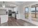 Modern kitchen with stainless steel appliances, gray backsplash, white cabinetry, hardwood floors, and natural light at 9353 Turkey Way, Middlesex, NC 27557