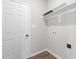 A clean laundry room with door to outside and basic hookups, featuring shelving and a bright interior at 9353 Turkey Way, Middlesex, NC 27557