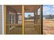 Spacious screened porch with wooden railing and ceiling fan at 9353 Turkey Way, Middlesex, NC 27557