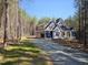 Under-construction, two-story home with shingled accent and ample natural light, nestled in a serene wooded area at 98 Fox Oak Trl, Pittsboro, NC 27312