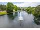 Breathtaking aerial view of a lake featuring a fountain and gazebo surrounded by mature trees and landscaping at 101 Listokin Ct, Cary, NC 27519