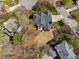 Stunning aerial view showcasing the home's backyard with lush green grass and beautiful backyard deck at 101 Listokin Ct, Cary, NC 27519