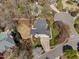 Bird's-eye view of a house showcasing the roofline, backyard and mature trees at 101 Listokin Ct, Cary, NC 27519