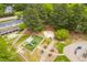Aerial view showcasing a community park featuring walking trails, playground equipment, and shaded picnic areas at 101 Listokin Ct, Cary, NC 27519