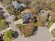 Aerial view of a property showcasing its well-maintained yard, mature trees, and neighborhood at 101 Listokin Ct, Cary, NC 27519