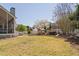 Spacious backyard with playhouse, slide and mature trees creating a great play area at 101 Listokin Ct, Cary, NC 27519