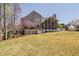 Expansive backyard showcasing a well-maintained lawn, deck and screened-in porch at 101 Listokin Ct, Cary, NC 27519
