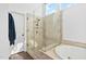 Bathroom featuring a glass enclosed shower with tile surround, linen closet, and transom windows at 101 Listokin Ct, Cary, NC 27519