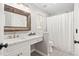 Bright bathroom with a framed mirror, vanity, tiled floors, and combined shower and tub at 101 Listokin Ct, Cary, NC 27519