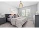Bedroom featuring a modern bed frame, neutral walls, and window at 101 Listokin Ct, Cary, NC 27519