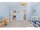 Light blue bedroom featuring a crib and modern lighting fixture at 101 Listokin Ct, Cary, NC 27519