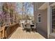 Outdoor deck area featuring a dining table set, grill, and a beautiful view of surrounding trees at 101 Listokin Ct, Cary, NC 27519