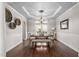 Formal dining room with tray ceiling, wainscoting, and a stylish chandelier at 101 Listokin Ct, Cary, NC 27519