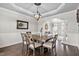Charming dining room featuring coffered ceilings, wainscoting, and hardwood floors at 101 Listokin Ct, Cary, NC 27519