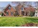 Stately brick home with lush lawn, mature trees, and covered entrance offers timeless elegance at 101 Listokin Ct, Cary, NC 27519