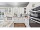 Bright kitchen featuring white cabinets, granite countertops, and stainless steel appliances at 101 Listokin Ct, Cary, NC 27519
