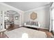 Bright living room with hardwood floors, a neutral color palette, and an open flow to the dining area at 101 Listokin Ct, Cary, NC 27519