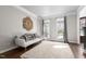 Cozy living room features hardwood floors, a decorative rug, and large windows with plenty of natural light at 101 Listokin Ct, Cary, NC 27519