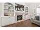 Living room featuring a brick fireplace, built-in shelving, and a comfortable sofa at 101 Listokin Ct, Cary, NC 27519