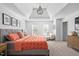 Spacious main bedroom features a trey ceiling and sitting area with a chair and footstool at 101 Listokin Ct, Cary, NC 27519