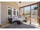 Well-lit screened porch with wicker seating, large windows, and scenic outdoor views at 101 Listokin Ct, Cary, NC 27519