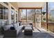 Inviting screened porch featuring cozy seating and a view of the blossoming trees outside at 101 Listokin Ct, Cary, NC 27519
