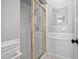 Clean bathroom with enclosed glass door shower and decorative mirror above the sink at 101 Listokin Ct, Cary, NC 27519