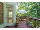 Cozy back deck with an umbrella-covered table, surrounded by lush greenery offering a serene outdoor retreat at 102 Battenburg Ct, Cary, NC 27519