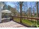 Spacious back deck with outdoor seating and a shady umbrella, overlooking a beautifully landscaped yard at 102 Battenburg Ct, Cary, NC 27519