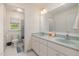 Neutral bathroom with double sinks, a large mirror, and separate toilet and shower at 102 Battenburg Ct, Cary, NC 27519
