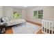 Cozy bedroom featuring hardwood floors, a comfortable bed, and a window at 102 Battenburg Ct, Cary, NC 27519