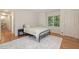 Cozy bedroom featuring hardwood floors, a comfortable bed, and a window at 102 Battenburg Ct, Cary, NC 27519
