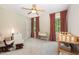 Bright bedroom featuring two windows, a ceiling fan, and a rocking chair, perfect for a Bedroom or guest room at 102 Battenburg Ct, Cary, NC 27519