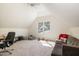 Bonus room with a grey sofa, study area, bean bag and carpeted floor perfect for relaxation and entertainment at 102 Battenburg Ct, Cary, NC 27519