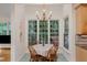 Charming breakfast nook with a large window view and a decorative chandelier at 102 Battenburg Ct, Cary, NC 27519