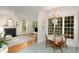 Cozy dining room adjacent to a living area, featuring hardwood floors, fireplace, and large windows at 102 Battenburg Ct, Cary, NC 27519