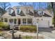 Charming home with a welcoming front porch, beautiful landscaping, and an attached garage at 102 Battenburg Ct, Cary, NC 27519