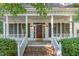Charming covered porch with ceiling fans, brick stairs, and meticulously maintained shrubbery at 102 Battenburg Ct, Cary, NC 27519