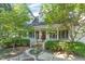 Beautiful house with a well-manicured lawn, mature trees, and a charming front yard at 102 Battenburg Ct, Cary, NC 27519