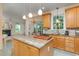 Well-lit kitchen featuring granite countertops, wooden cabinets, and stainless steel appliances at 102 Battenburg Ct, Cary, NC 27519