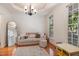 Inviting living room featuring hardwood floors, a large window, and elegant tray ceiling at 102 Battenburg Ct, Cary, NC 27519