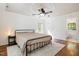 Spacious main bedroom featuring hardwood floors, a ceiling fan, and a walk-in bathroom at 102 Battenburg Ct, Cary, NC 27519
