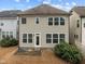 The backyard features a two-story house with a door and many windows at 105 Concordia Woods Dr, Morrisville, NC 27560