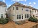 View of the backyard of the two-story house with a door and many windows at 105 Concordia Woods Dr, Morrisville, NC 27560