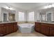 Stylish bathroom with a corner soaking tub nestled between and vanities at 105 Concordia Woods Dr, Morrisville, NC 27560