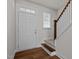 Bright entrance featuring a staircase, hardwood floors and a white front door at 105 Concordia Woods Dr, Morrisville, NC 27560