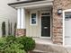 Inviting front entrance with stone accents, green bushes and a covered porch at 105 Concordia Woods Dr, Morrisville, NC 27560