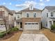 Inviting two-story home featuring stone accents and a two-car garage on a sunny day at 105 Concordia Woods Dr, Morrisville, NC 27560